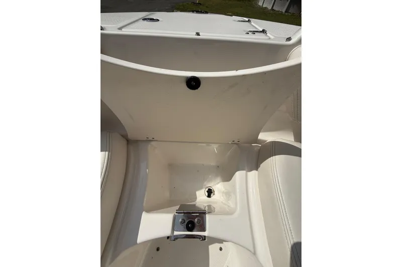 Slide: The Image of 2016 Chaparral 224 Sunesta boat interior storage compartment, open and empty. - 29