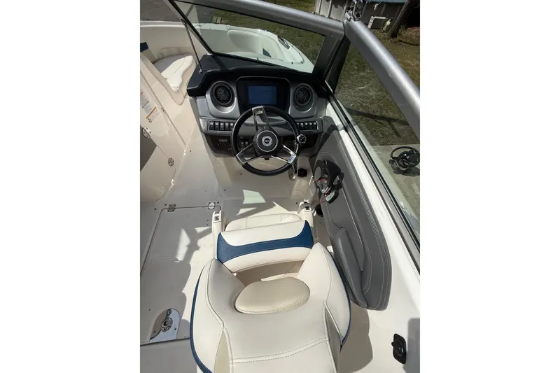 Slide: The Image of Interior view of 2016 Chaparral 224 Sunesta boat cockpit with steering wheel and controls. - 31