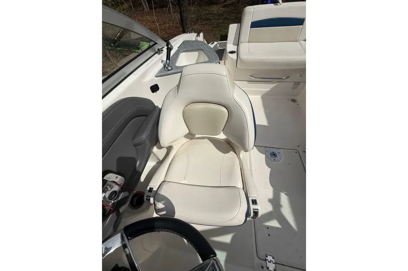 Slide: The Image of 2016 Chaparral 224 Sunesta boat interior with white seating and steering wheel. - 33