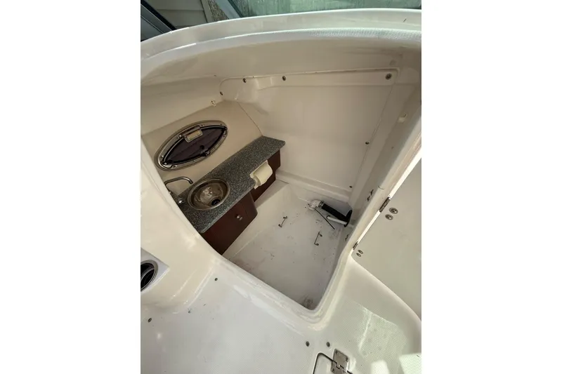 Slide: The Image of Interior of 2016 Chaparral 224 Sunesta boat with sink and storage area. - 37