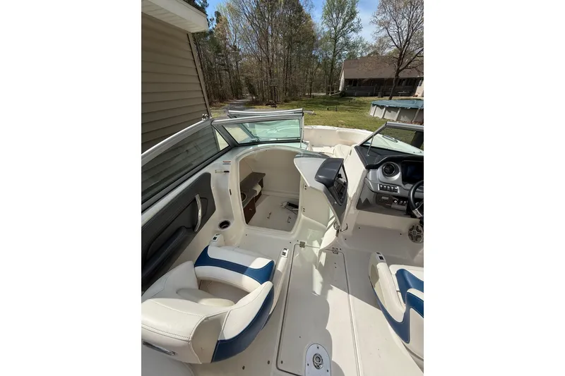 Slide: The Image of Interior view of 2016 Chaparral 224 Sunesta boat, featuring seating and control panel. - 38
