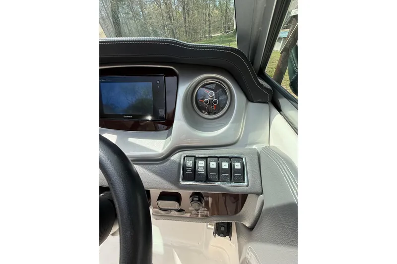 Slide: The Image of 2016 Chaparral 224 Sunesta dashboard with Garmin display and control switches. - 39