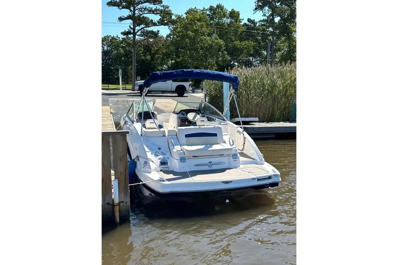 Slide: The Image of 2016 Chaparral 224 Sunesta boat docked at a marina with blue canopy. - 4