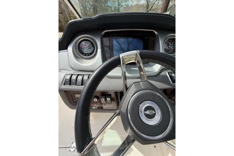 Slide: The Image of Steering wheel and dashboard of 2016 Chaparral 224 Sunesta boat. - 41