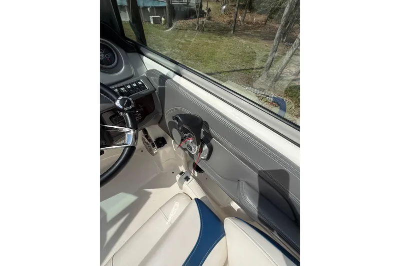 Slide: The Image of Interior view of 2016 Chaparral 224 Sunesta boat cockpit with steering wheel and controls. - 42