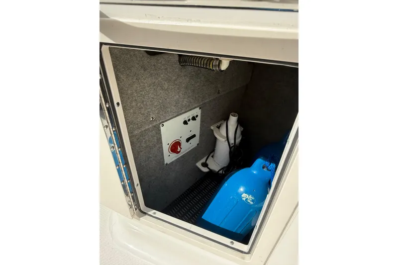 Slide: The Image of Storage compartment of 2016 Chaparral 224 Sunesta boat with equipment and controls. - 45