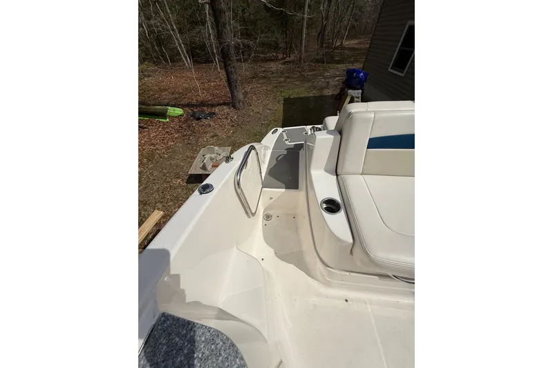 Slide: The Image of 2016 Chaparral 224 Sunesta boat interior with seating and cup holders. - 46