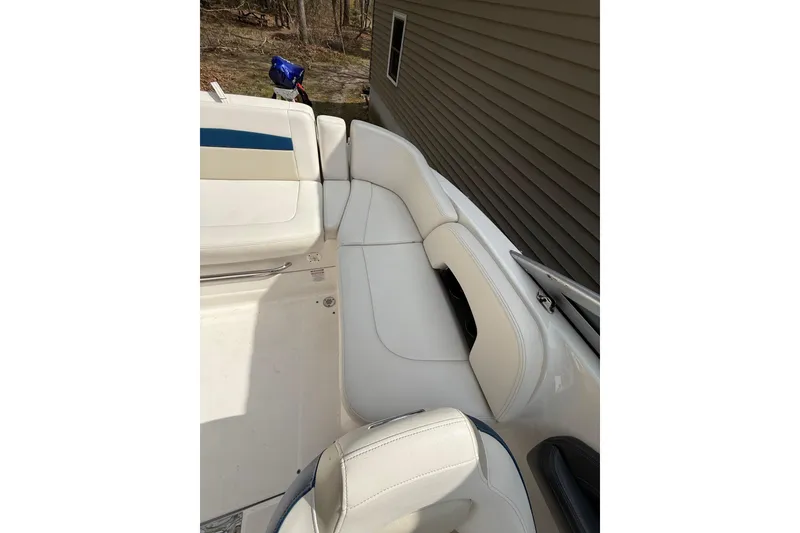 Slide: The Image of 2016 Chaparral 224 Sunesta boat interior with white seating and blue accents. - 48