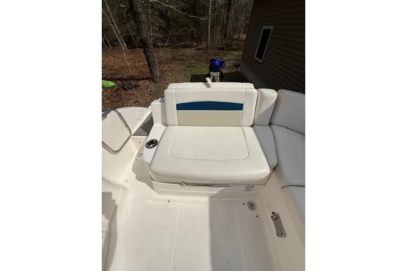 Slide: The Image of 2016 Chaparral 224 Sunesta boat interior with white seating and blue accent. - 49