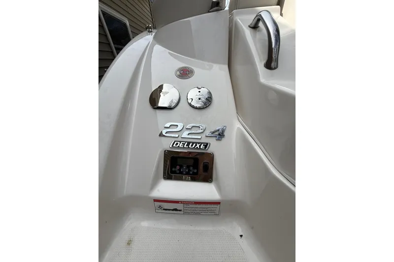 Slide: The Image of 2016 Chaparral 224 Sunesta boat rear view with model emblem and deluxe badge. - 51