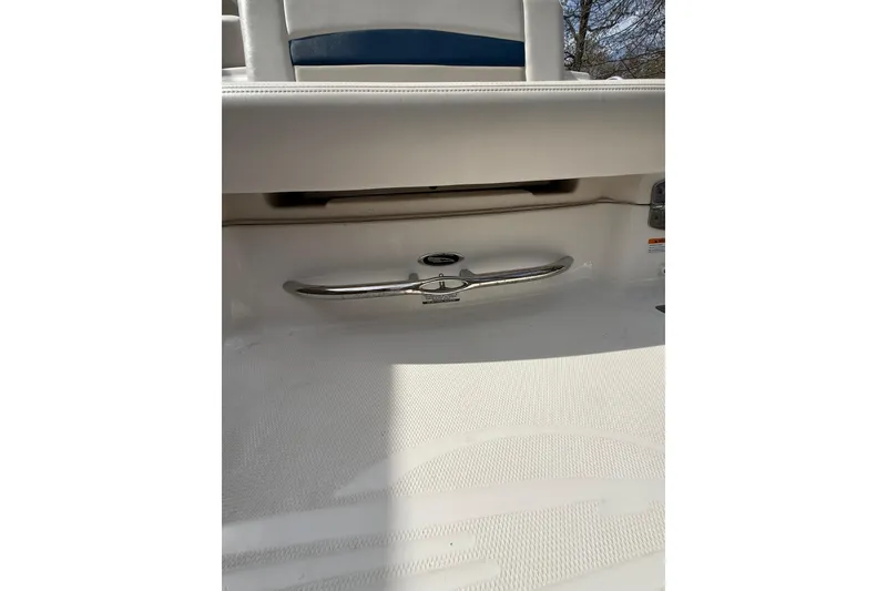 Slide: The Image of 2016 Chaparral 224 Sunesta boat interior detail with chrome handle and white seating. - 52