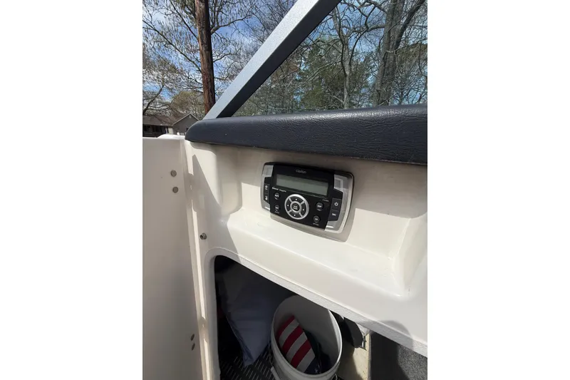Slide: The Image of 2016 Chaparral 224 Sunesta boat dashboard with stereo system, outdoor setting. - 58