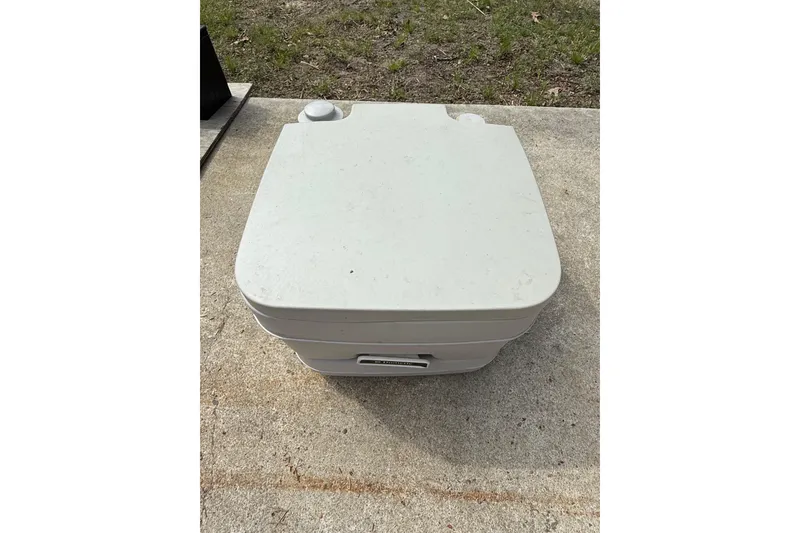 Slide: The Image of Portable toilet on concrete, associated with 2016 Chaparral 224 Sunesta boat. - 59