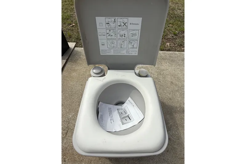 Slide: The Image of Portable toilet with instructions, outdoors on concrete, associated with Chaparral 224 Sunesta 2016. - 60