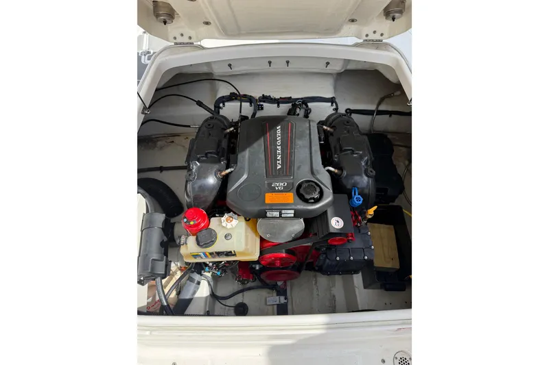 Slide: The Image of Engine compartment of a 2016 Chaparral 224 Sunesta boat featuring a Volvo Penta V6 engine. - 66