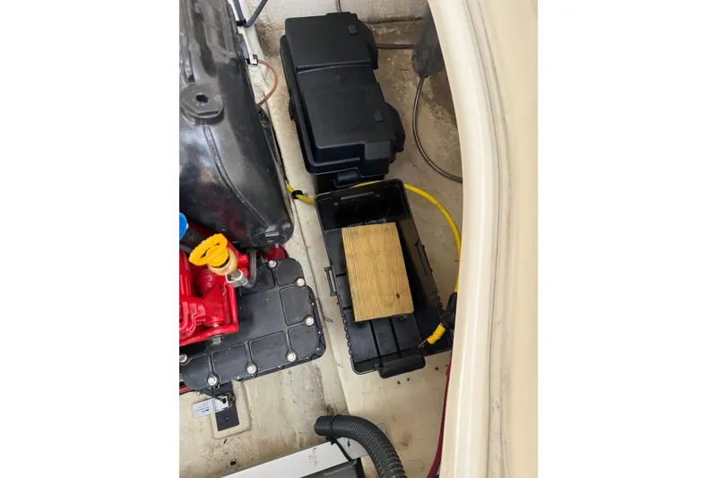 Slide: The Image of 2016 Chaparral 224 Sunesta engine compartment with battery boxes and wiring. - 69