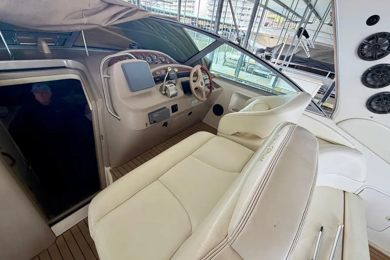 Slide: The Image of Interior view of a 2001 Sea Ray 340 Sundancer boat cockpit with steering wheel and controls. - 13