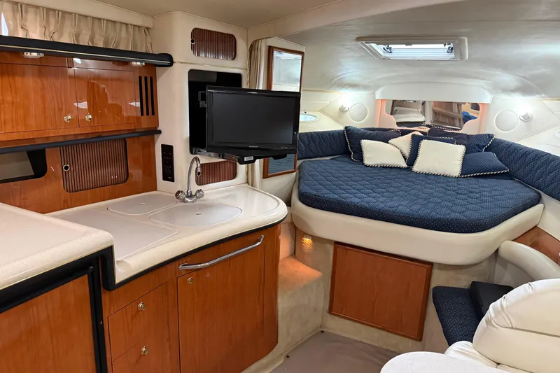 Slide: The Image of Interior of 2001 Sea Ray 340 Sundancer with kitchenette and cozy sleeping area. - 15