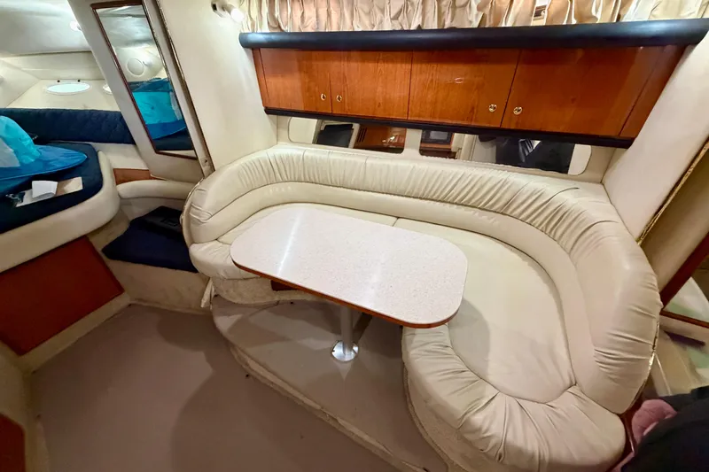 Slide: The Image of Interior of 2001 Sea Ray 340 Sundancer with cream leather seating and wooden cabinetry. - 18