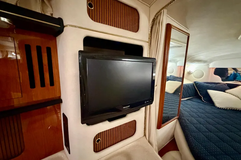 Slide: The Image of Interior of a 2001 Sea Ray 340 Sundancer with TV and cozy bedding. - 20