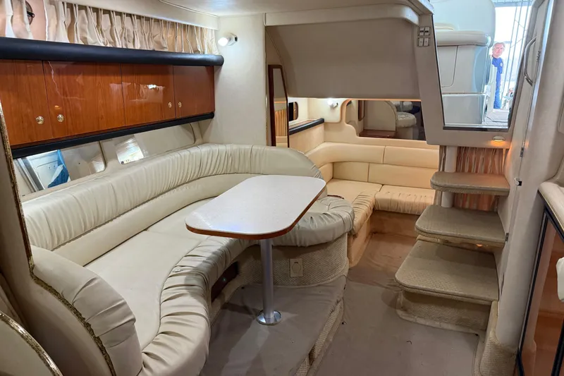 Slide: The Image of Interior of 2001 Sea Ray 340 Sundancer yacht with plush seating and dining area. - 21