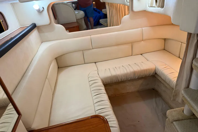 Slide: The Image of Interior of 2001 Sea Ray 340 Sundancer yacht with beige seating and cozy layout. - 22