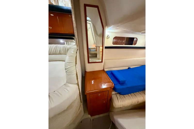 Slide: The Image of Interior of 2001 Sea Ray 340 Sundancer with mirror, wooden cabinet, and seating area. - 23