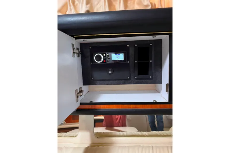 Slide: The Image of Open cabinet with control panel inside a 2001 Sea Ray 340 Sundancer boat. - 25