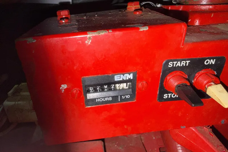 Slide: The Image of Red control panel with hour meter and switches on a 2001 Sea Ray 340 Sundancer. - 31