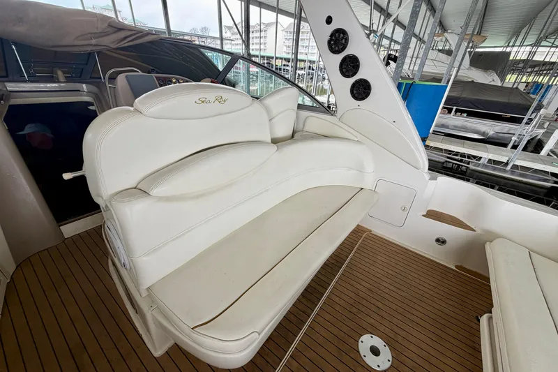Slide: The Image of 2001 Sea Ray 340 Sundancer boat interior with white seating and wood flooring. - 4