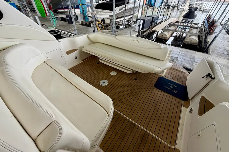 Slide: The Image of 2001 Sea Ray 340 Sundancer boat interior with white seating and wooden deck. - 5