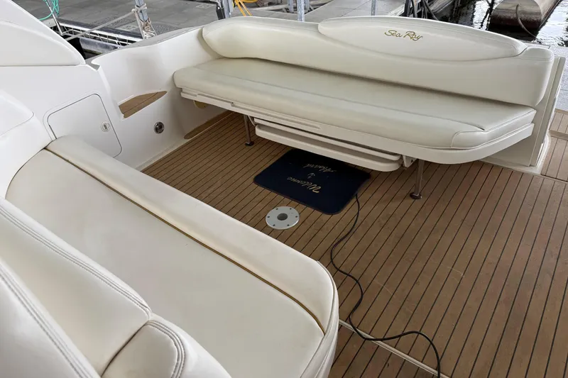 Slide: The Image of 2001 Sea Ray 340 Sundancer boat interior with white seating and wooden deck. - 6