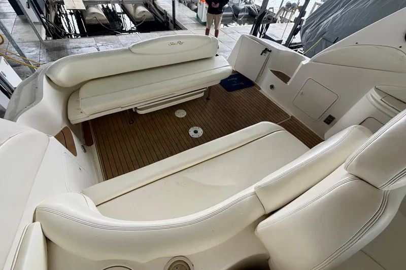 Slide: The Image of 2001 Sea Ray 340 Sundancer boat interior with white seating and wooden flooring. - 7