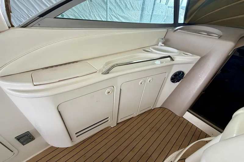 Slide: The Image of 2001 Sea Ray 340 Sundancer interior with sink and storage on teak flooring. - 8