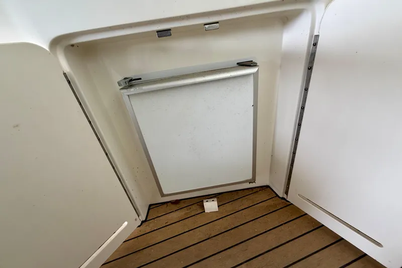 Slide: The Image of 2001 Sea Ray 340 Sundancer cabin interior with a closed storage compartment. - 9