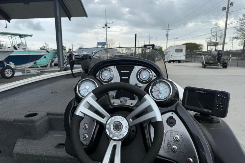 Slide: The Image of 2022 Tracker Pro Team 190 TX Tournament Edition boat dashboard with steering wheel and gauges. - 12