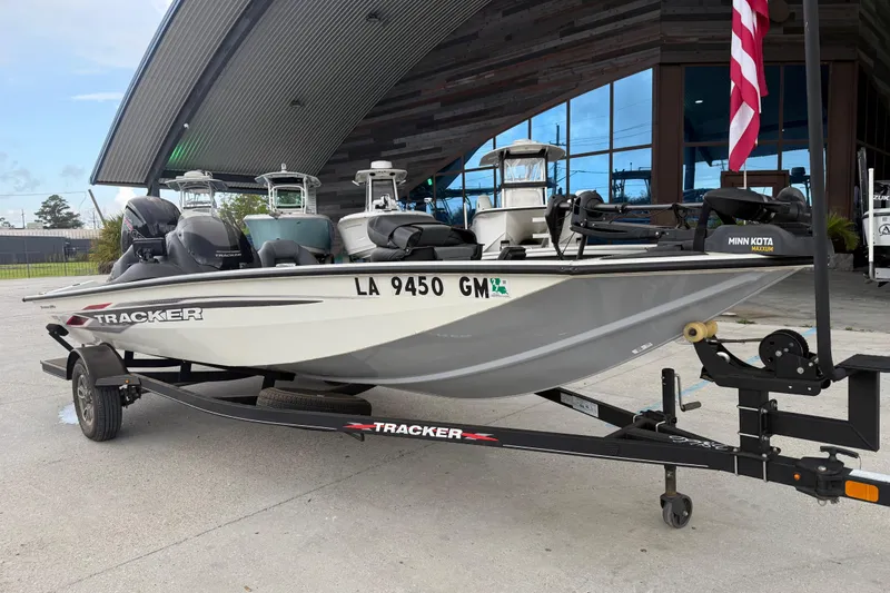 Slide: The Image of 2022 Tracker Pro Team 190 TX Tournament Edition boat on trailer, parked outdoors. - 2