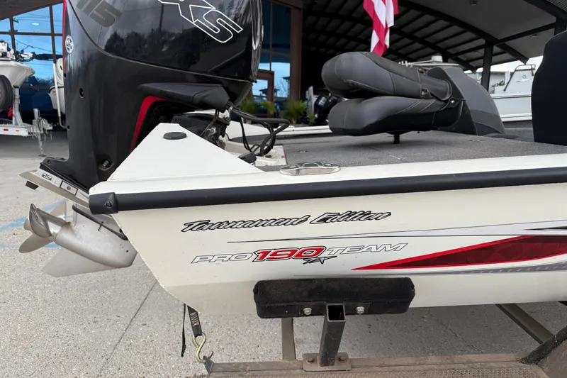 Slide: The Image of 2022 Tracker Pro Team 190 TX Tournament Edition boat with motor, docked outdoors. - 3