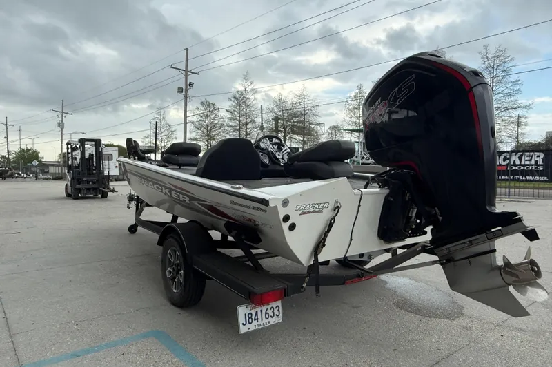 Slide: The Image of 2022 Tracker Pro Team 190 TX Tournament Edition boat on trailer, parked outdoors. - 6