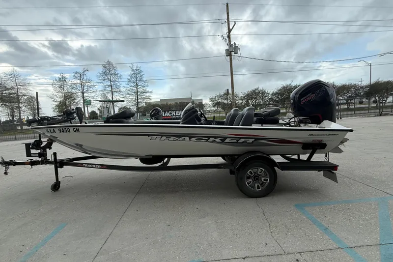Slide: The Image of 2022 Tracker Pro Team 190 TX Tournament Edition boat on trailer, parked outdoors. - 7