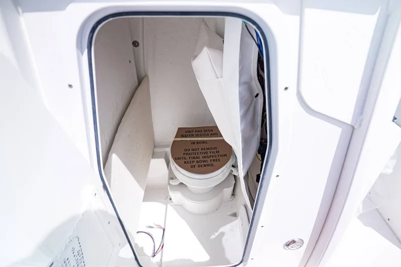 Slide: The Image of Interior of Sea Hunt Ultra 245 SE 2026 with toilet. - 21