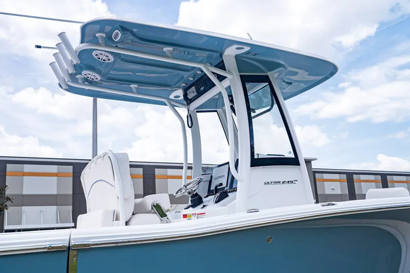 Slide: The Image of 2026 Sea Hunt Ultra 245 SE with modern helm and blue canopy. - 28
