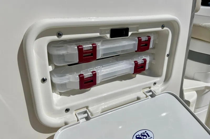 Slide: The Image of Boston Whaler 190 Montauk 2026, integrated storage with red latches. - 11