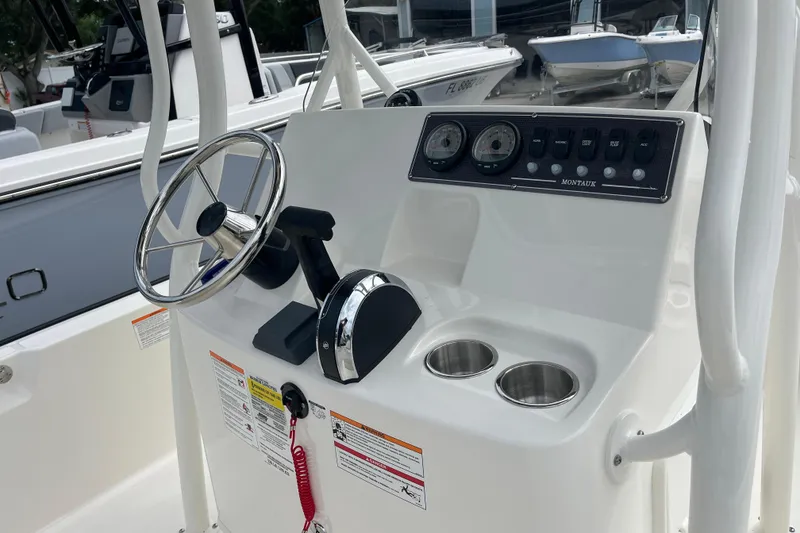 Slide: The Image of Boston Whaler 190 Montauk 2026 helm with steering wheel and controls. - 5