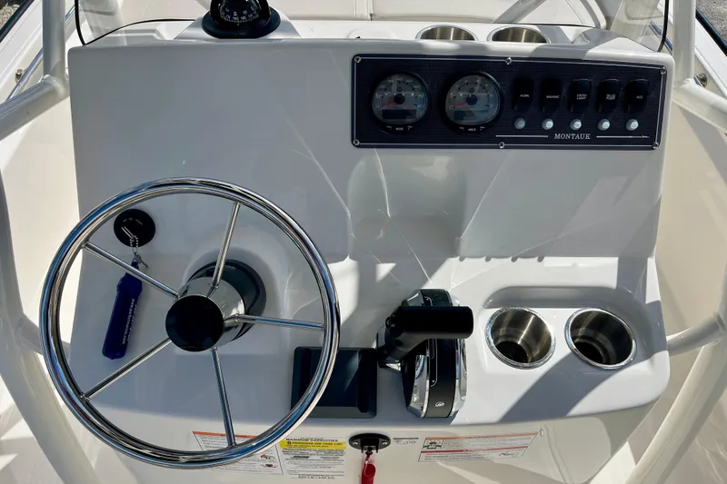 Slide: The Image of Boston Whaler 190 Montauk 2026 helm with steering wheel and gauges. - 8