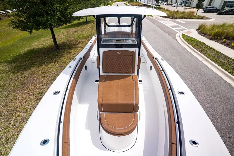 Slide: The Image of 2026 Sea Hunt ULTRA 285CB with brown upholstery, parked on road. - 21
