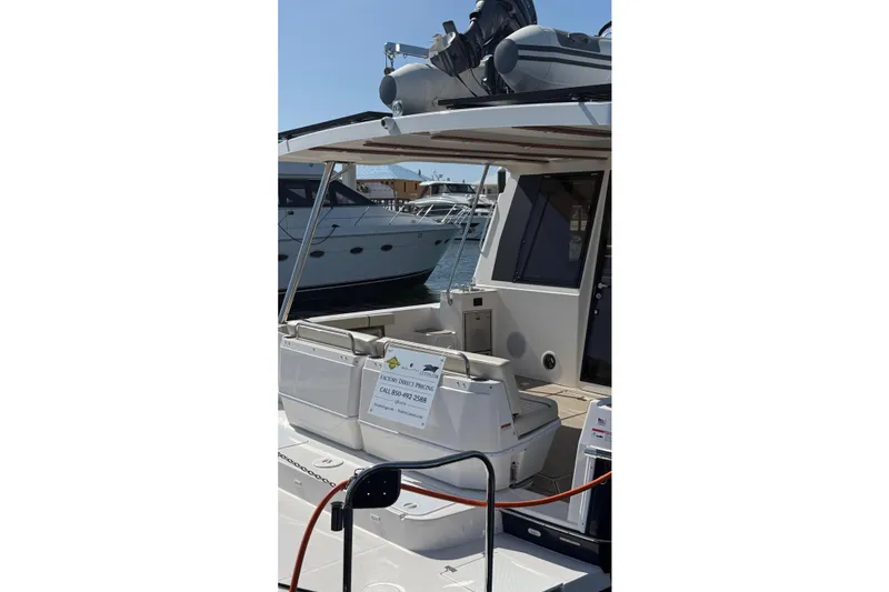 Slide: The Image of 2026 Ranger Tugs R-43 CB yacht docked, showcasing rear seating and deck area. - 11