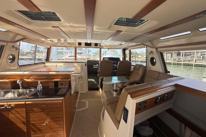 Slide: The Image of Interior of 2026 Ranger Tugs R-43 CB yacht, featuring luxurious seating and modern amenities. - 14