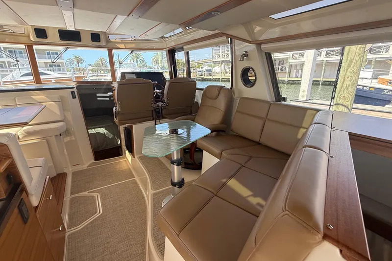 Slide: The Image of Luxurious interior of 2026 Ranger Tugs R-43 CB yacht with leather seating and glass table. - 15