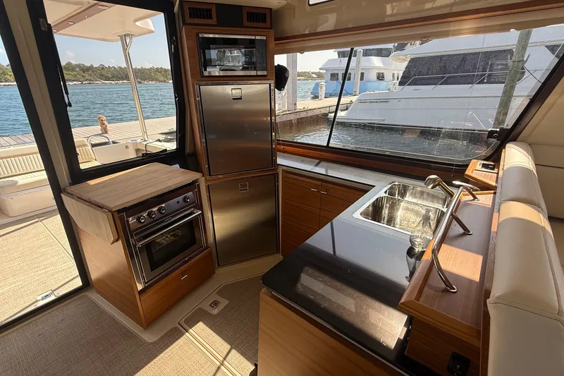 Slide: The Image of Luxurious 2026 Ranger Tugs R-43 CB yacht kitchen with modern appliances and waterfront view. - 16